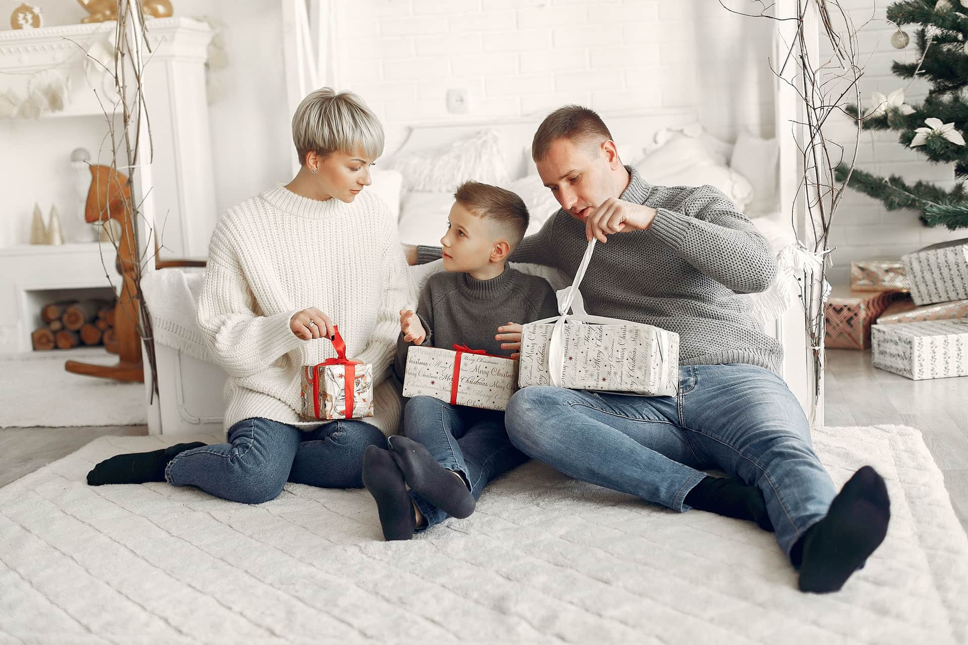 A family opening gifts together at home