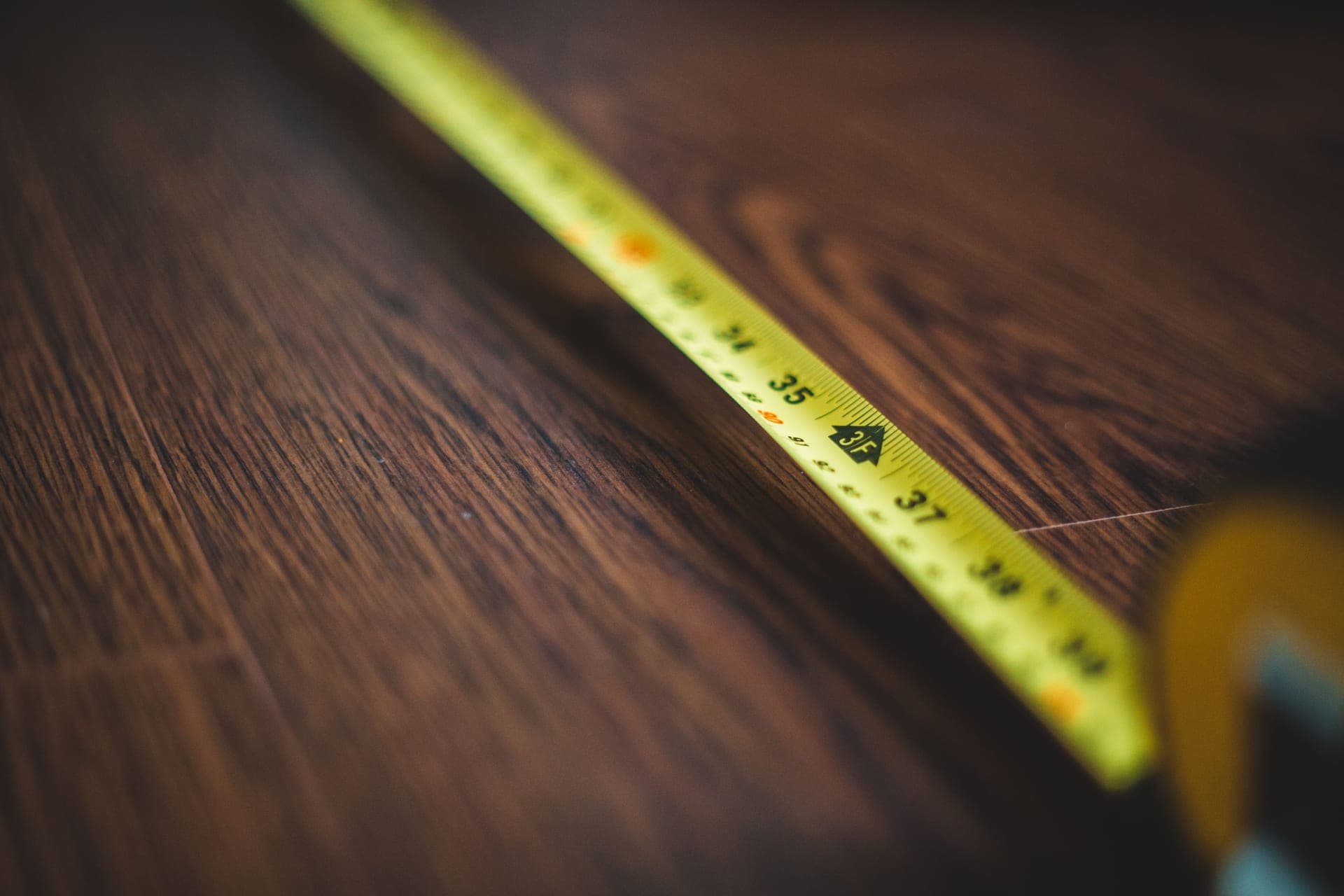 A tape measure extended across a wooden floor
